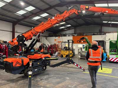 Spider crane hire being operated indoors by remote control